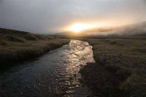 calm river flowing  plain  sunset  stock photo