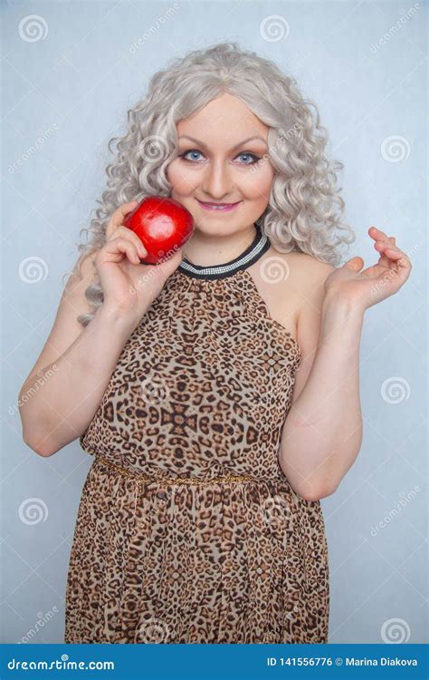 Chubby Blonde Girl Wearing Summer Dress And Posing With Big Red Apple