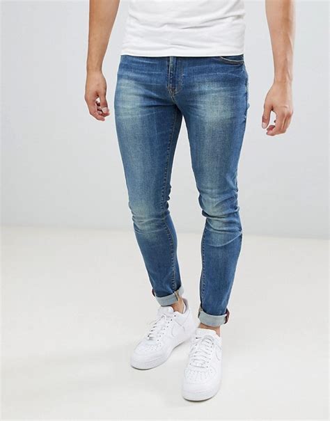 asos design skinny jeans in mid blue wash asos