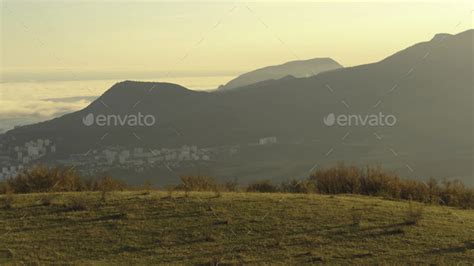 panoramic view of the scenic autumn valley from a steep bushy slope on