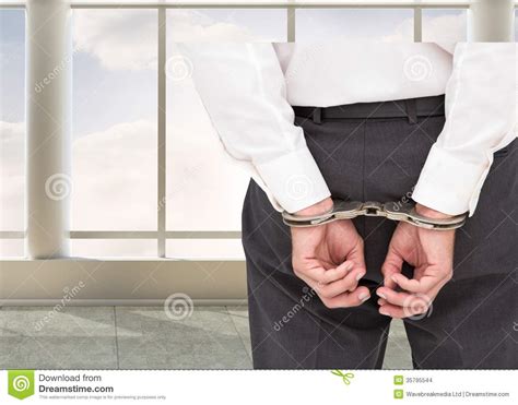 close up on classy businessman wearing handcuffs stock