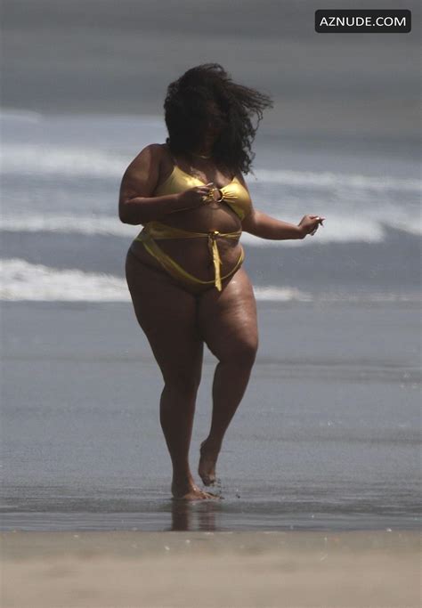 Lizzo Stands In A Tiny Metallic Gold One Piece Whilst With Her