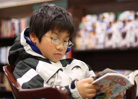 fileyoung boy reading mangajpg wikimedia commons
