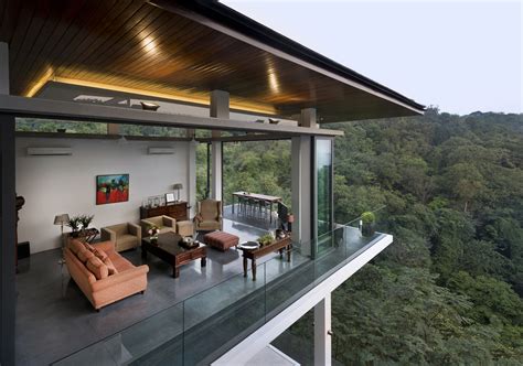 dramatic modern house   lush urban forest reserve