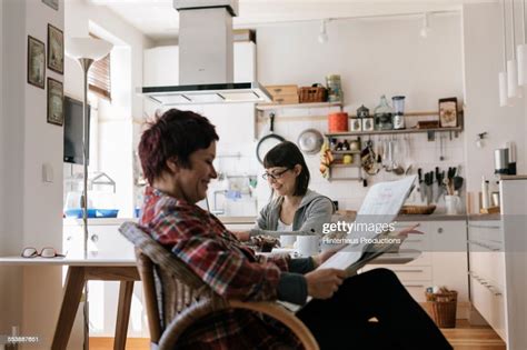 Lesbian Couple In Their Kitchen Photo Getty Images