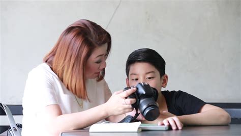 asian mother and son looking and shoot with dslr camera together stock footage video 13768820