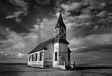 Black And White Of An Old Church In Front Of A Radio Tower