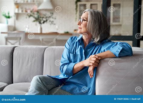 Calm Relaxed Mature Older Woman Relaxing Sitting On Couch At Home My