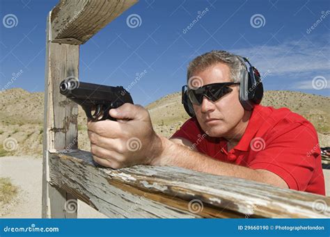 man aiming hand gun  firing range stock photo image