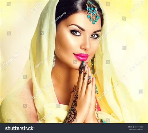 Beauty Indian Girl With Mehndi Tattoos Hold Palms Together