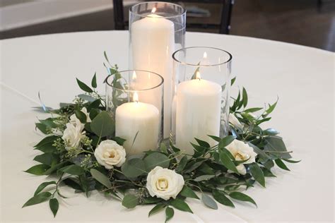 wedding centerpieces  candles  greenery