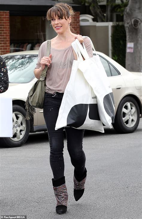 Milla Jovovich Dazzles As She Flashes Her Bra As She Steps Out Shopping