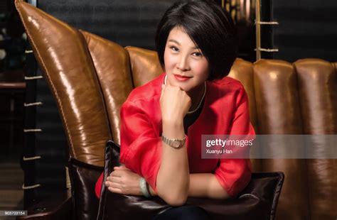 mature chinese businesswoman sitting on sofa photo getty images