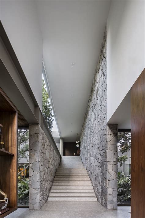 The Stairs Lead Up To The Upper Level Of This Modern House With Stone