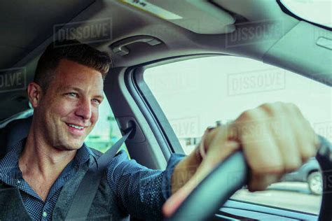 smiling caucasian man driving car stock photo dissolve