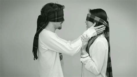 blindfolded strangers kiss each other in an adorable