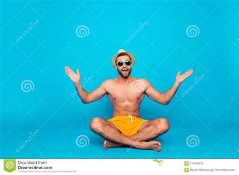 cheerful funny attractive ladies` man with naked torso in yel stock