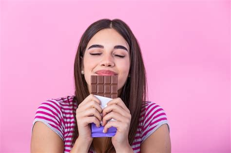 Premium Photo Cute Young Woman Eating Chocolate