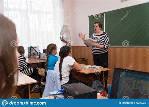 teacher with blackboard cursive handwriting editorial image