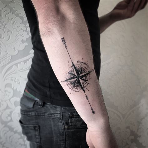 detailed compass and arrow tattoo by bartek selfmade tattoo berlin