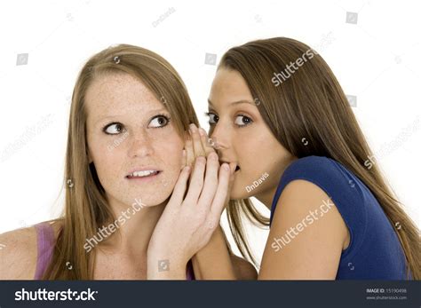 Two Beautiful Caucasian Women Telling Secret On A White Background