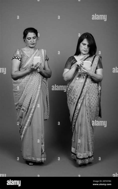 two mature indian women wearing sari indian traditional clothes
