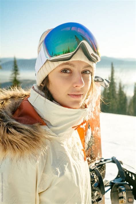 cheerful girl holding a snowboard sunny clear weather winters del