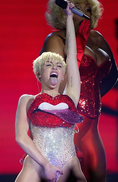miley cyrus tells london audience to ‘kiss members of the same sex and take pills — but says