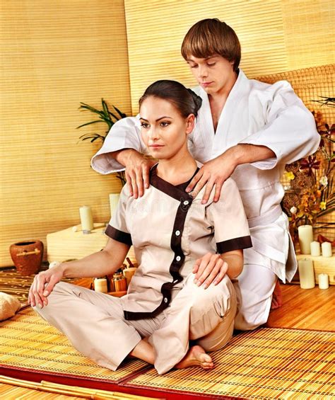 Male Masseur Doing Massage Woman In Bamboo Spa Stock Image Image Of