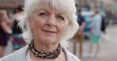 slow motion portrait of happy mature old woman smiling in city real people series stock footage