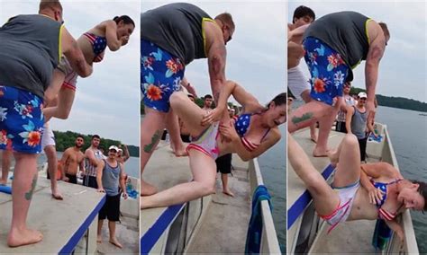 man chucks girls from boat only for her to fall neck first onto railings in video daily mail