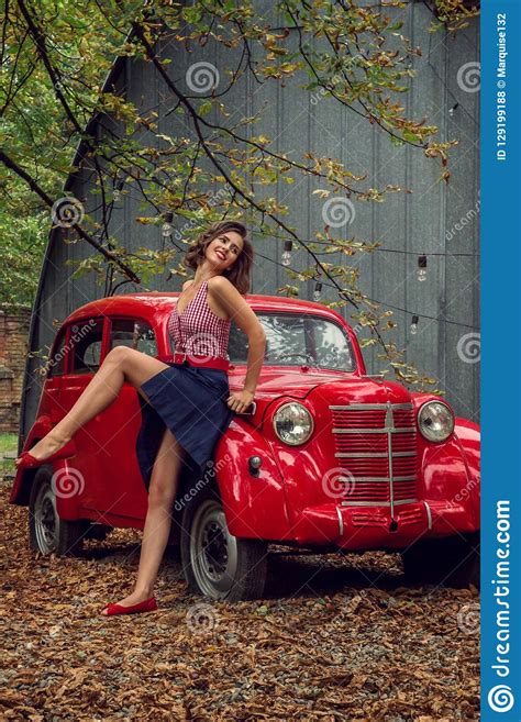 emotional portrait pin up girl posing near by a red russian retro car the model laughs loudly