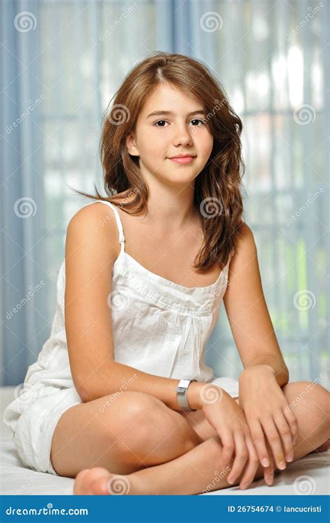 beautiful teen girl  home  white dress stock photo image