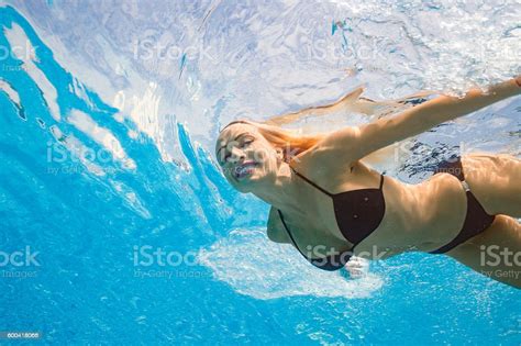 underwater pool party woman swimming relaxing in swimming pool stock