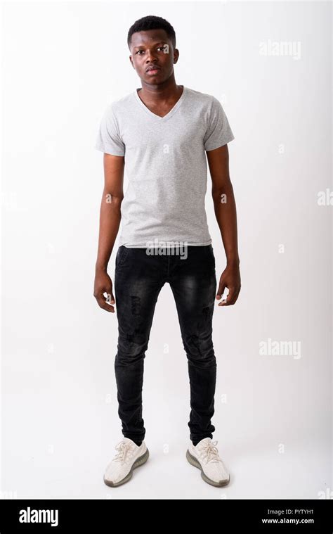 full body shot  young black african man standing  white stock