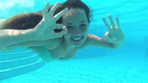 Woman Swimming Underwater In Slow Motion Stock Footage
