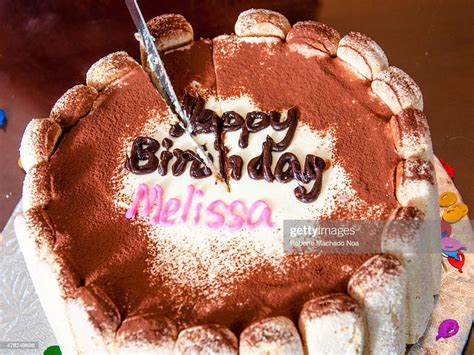 a decorated birthday cake says happy birthday melissa in icing the