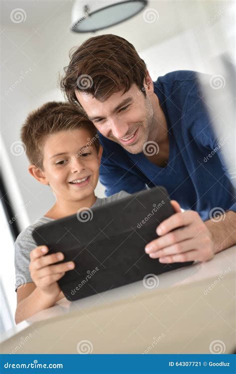 portrait of father and son websurfing stock image image of device