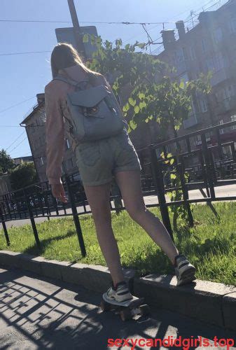 Girl In Denim Shorts On Skateboard Street Candid Photos