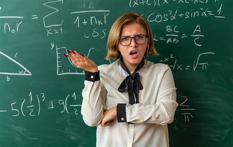 Free Photo Confused Young Female Teacher Wearing Glasses Standing In