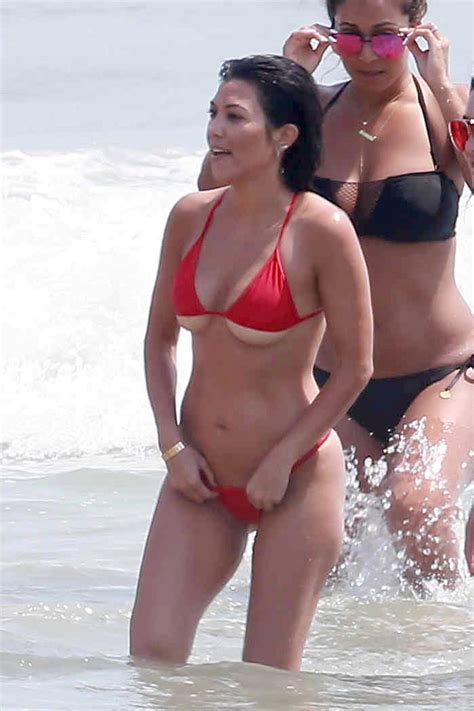 amazing new pictures show kim kardashian and kourtney in bikinis on the beach in candid glimpse