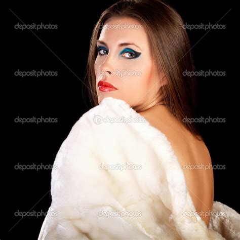 Woman In Fur On Black Background With Naked Back Posing On Camer ⬇