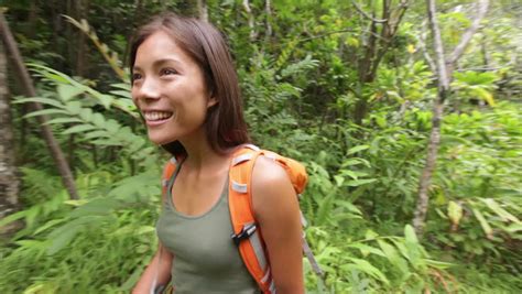 hiking woman trekking in rainforest jungle rear back view