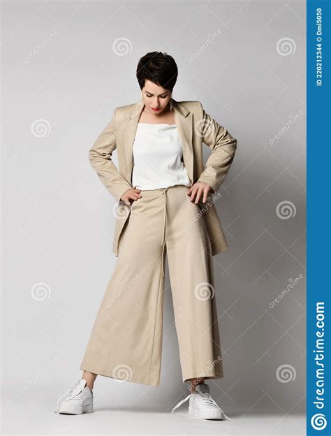 Pretty Short Haired Brunette Woman In Beige Business Smart Casual Suit