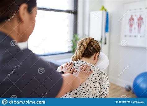 chinese woman massage therapist giving a neck and back pressure