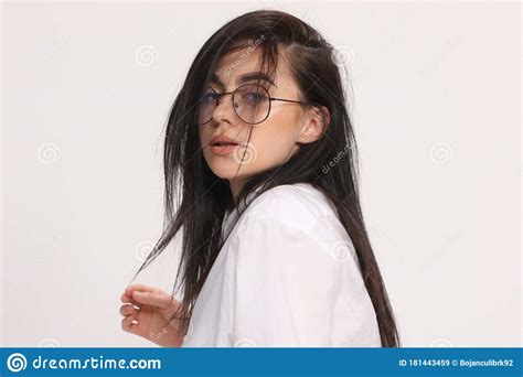 Beautiful Caucasian Hipster Girl With Black Hair And Glasses Is Posing