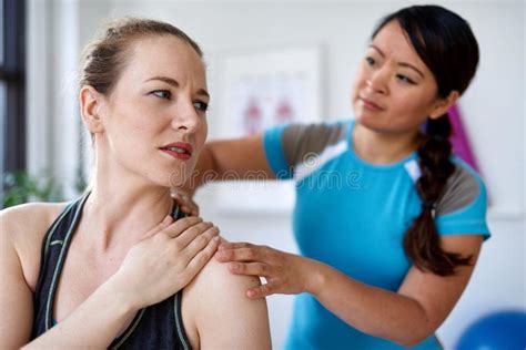 chinese woman massage therapist giving a treatment to an attractive