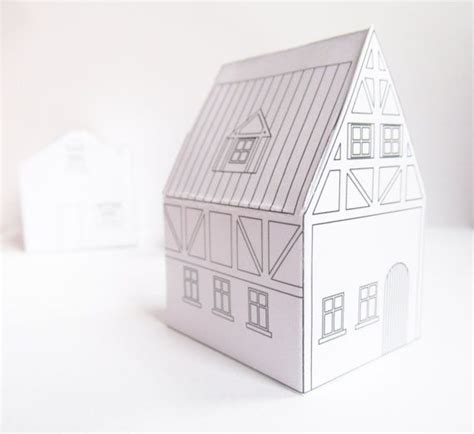paper model   house sitting  top   white table