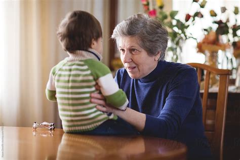 Grandmother Talking To Her Grandson By Stocksy Contributor Nasos