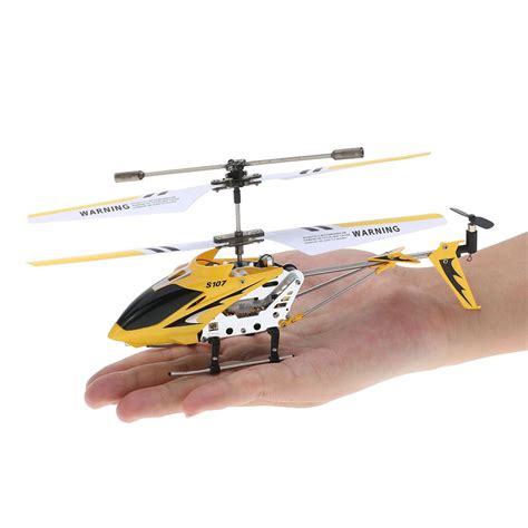 hand holding  yellow  black remote control helicopter    hand
